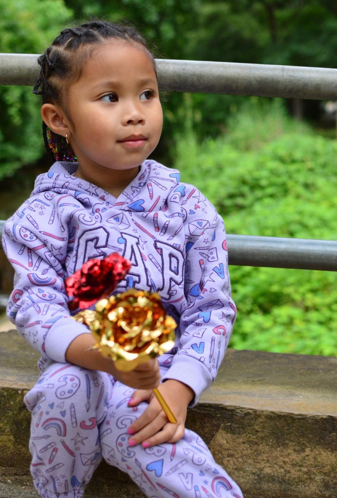 Close-up portrait of Milani in a lavender hoodie